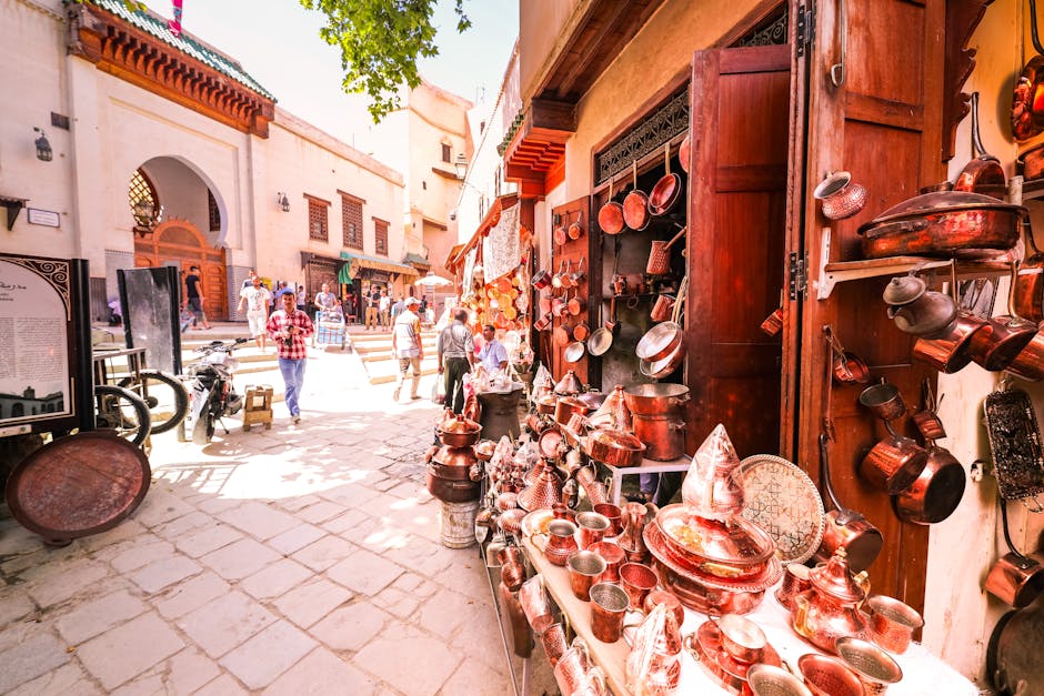 A bustling Moroccan street market showcasing copper goods in a vibrant medina setting.